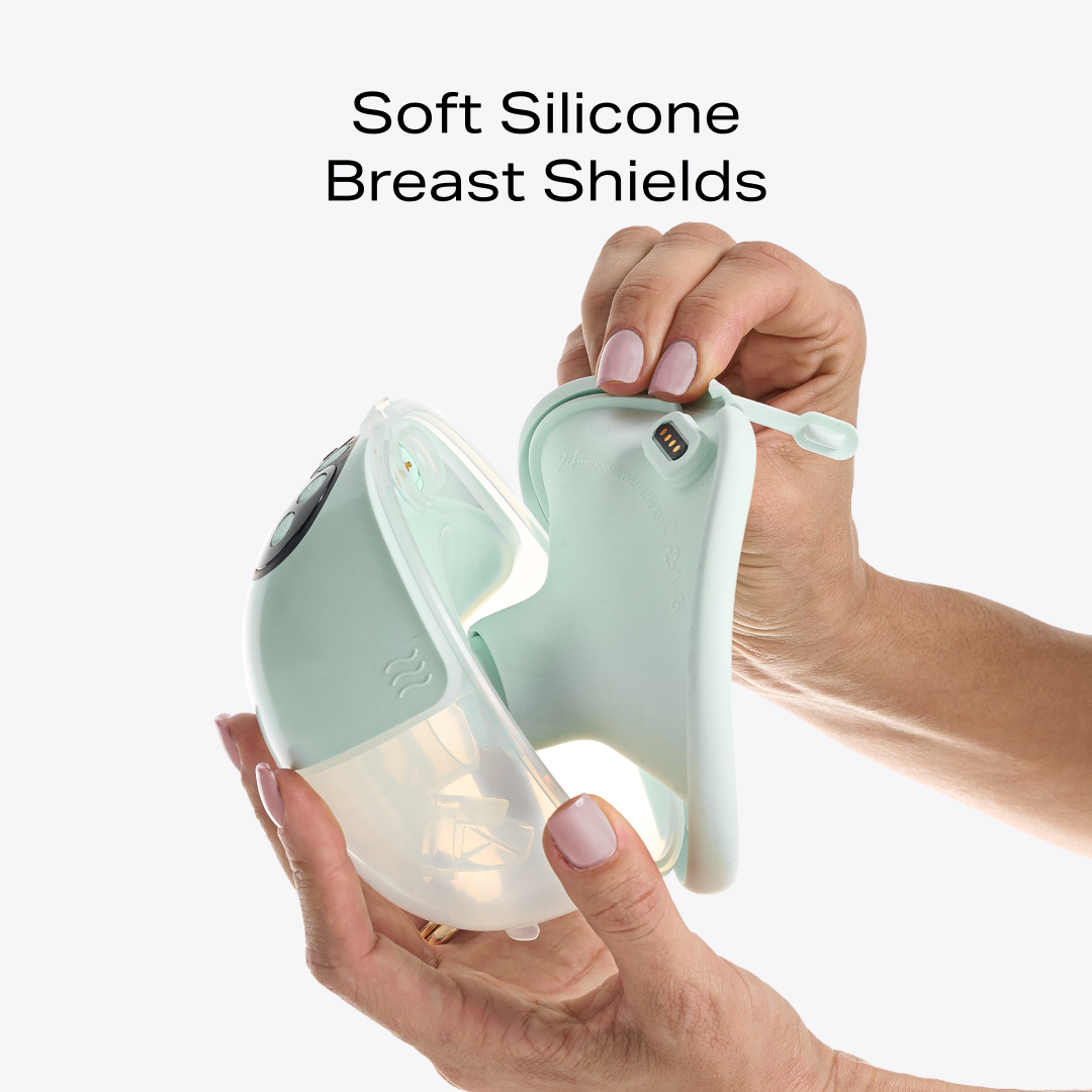 Hands pulling apart the W1 breast pump to show the soft silicone breast shield