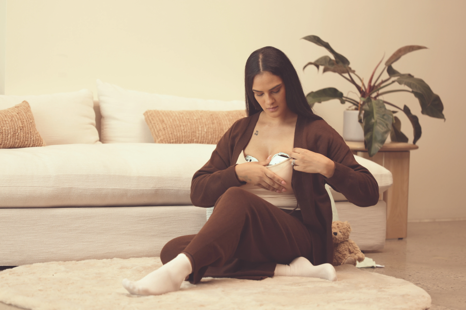 mom putting on her wearable breast pump
