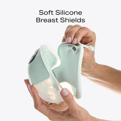 Hands pulling apart the W1 breast pump to show the soft silicone breast shield 
