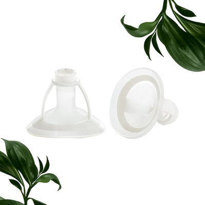 Two of the Mother’s Nature H1 Breast Pump Flanges with green plant leaves on the bottom left and top right