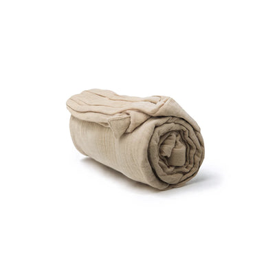 rolled up beige muslin nursing cover