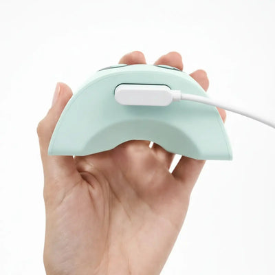 close up of the magnetic charging cable connected to the zomee mother's nature w1 breast pump